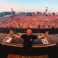 Photograph of Anton Powers standing in front of a huge crowd at a music festival
