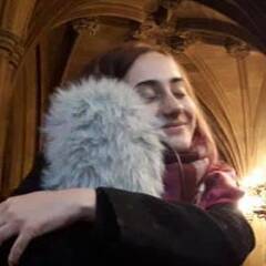 Photograph of Rebecca Braybrook hugging a big furry microphone